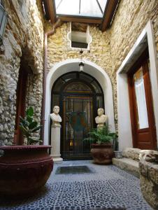 a entrance to a building with a door with statues at Palazzo Lupis B & B Grotteria Calabria Italia in Grotteria