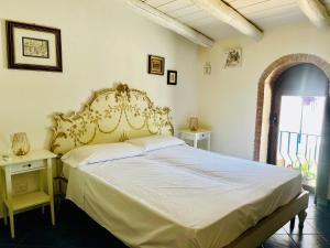 a bedroom with a large bed with a gold headboard at Borgo Camicia In in Barcellona-Pozzo di Gotto