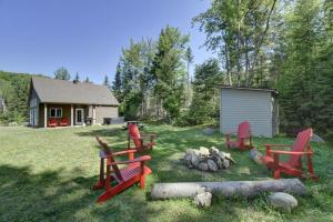 a group of chairs sitting in the grass in a yard at 46 Impasse - Lac Superior Getaway 3BR Home w Hot Tub in Mont-Tremblant