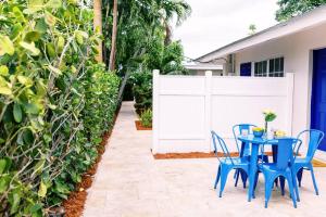 a blue table and chairs on a patio at Casa Cordova Apartments By Lowkl in Fort Lauderdale