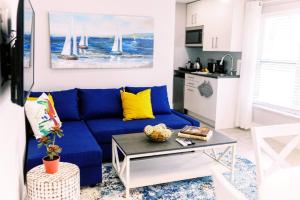 a blue couch in a living room with a table at Casa Cordova Apartments By Lowkl in Fort Lauderdale