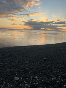 a sunset on a beach with the ocean at Beach side Duplex in Punaauia