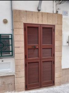 a wooden door on the side of a building at Casa Emilia in Monopoli