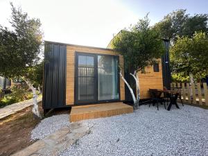 a small cabin with a table in front of it at Gaia Tiny Houses Butik Hotel in Bodrum City