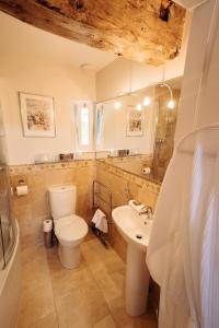 a bathroom with a toilet and a sink at The Old Coach House in Ripon