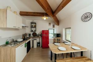 a kitchen with a table and a red refrigerator at Chez Janick & Hervé in Lemps