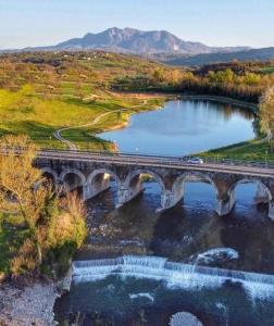 a bridge over a river with a train on it at B&B da Maria & Renato il Lago Trattoria in Mirabella Eclano