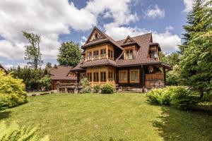 una gran casa de madera con un gran patio en Willa Jasinek, en Zakopane