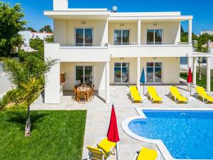 a villa with a swimming pool and a house at Villa Impasse - Albufeira in Albufeira