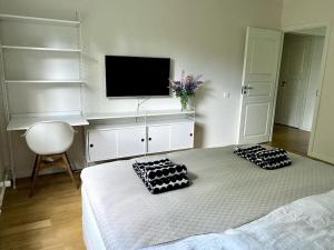 a bedroom with a bed with two pillows on it at 2 br apartment w/ balcony, wifi, parking in Espoo