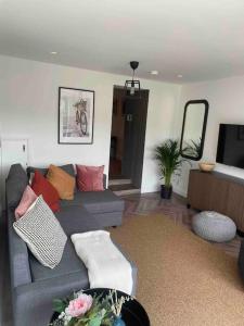a living room with a couch and a tv at ROOMZ TOWNHOUSE NO 20 in Portaferry