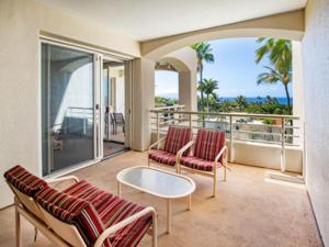 a balcony with two chairs and a table on a balcony at Palms at Wailea in Wailea