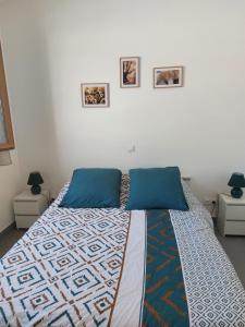 a bedroom with a bed with a colorful quilt on it at Chez Laurie et Jo in Saint-Remèze