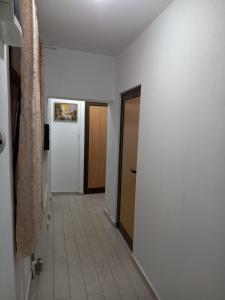 a hallway with two doors and a tile floor at CAZARE Centrum in Curtea de Argeş