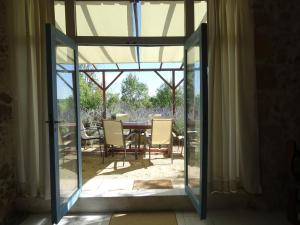 an open door to a patio with a table and chairs at GersGites in Justian
