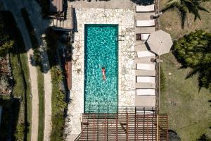 an overhead view of a swimming pool with a person in it at Casa Grande Mountain Retreat - Adults Only in Utuado
