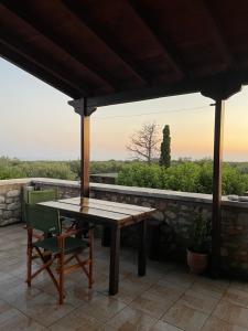 a table and chairs on a patio with a view at Torre di Maina in Kharoúdha