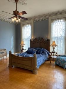 a bedroom with a bed with a blue comforter at Upjohn in Kalamazoo