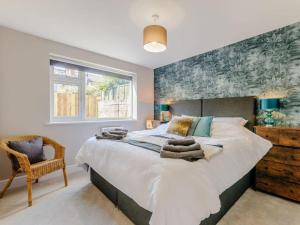 a bedroom with a large bed and a chair at Walpole BACK House sleeps 6-8 in Margate