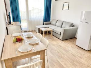 a kitchen and living room with a table and a couch at Central Seaview Apartments for 4 Guests in Sveti Vlas