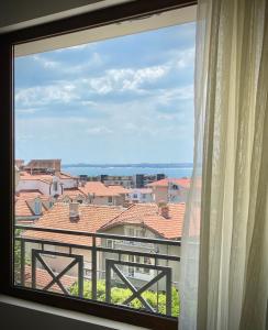 a window with a view of a city at Central Seaview Apartments for 4 Guests in Sveti Vlas