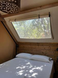 a bed in a room with a window at TENUTA IL GUERRIERO in Capestrano