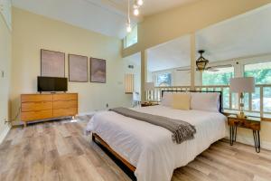 a bedroom with a large bed and a television at Spacious Little Rock Home with Yard and Game Room in Little Rock