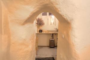 an archway in a room with a sink and a window at Industrial-style studio with bathtub, Vieux-Lyon in Lyon