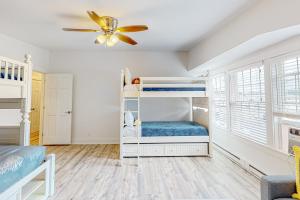 a bedroom with bunk beds and a ceiling fan at Whale's Tale in Boothbay Harbor