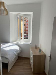 a bedroom with a bed and a window at Grand appartement hyper centre Grasse in Grasse +9 photos