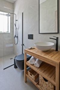 a bathroom with a sink and a toilet and a shower at Arokaria in Ierápetra