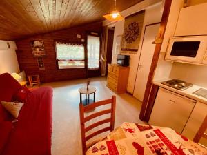 a living room with a kitchen and a table and a room at Studio La Clusaz, 1 pièce, 4 personnes - FR-1-459-61 in La Clusaz