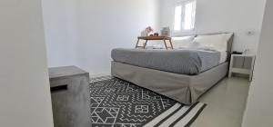 a bedroom with a bed and a fireplace at Lemon Tree Houses in Áno Meriá
