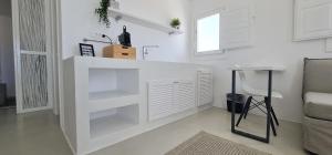 a white kitchen with a counter in a room at Lemon Tree Houses in Áno Meriá