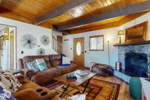 a living room with a couch and a fireplace at House of the Rising Sun in Lake Arrowhead