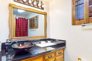 a bathroom with a sink and a mirror at House of the Rising Sun in Lake Arrowhead +22 photos