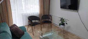 sala de estar con 2 sillas y sofá en Pakeliui, en Kaunas