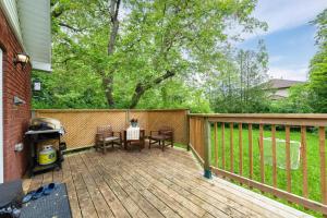 a patio with a table and chairs on a deck at Close to mall with private toilet, Free Wi-Fi and Parking in Toronto