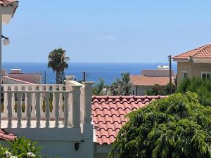 a balcony of a house with the ocean in the background at Villa Tamara with Private Pool in Peyia