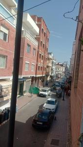 a street with cars parked on the side of the road at إقامة الصداقة in Larache