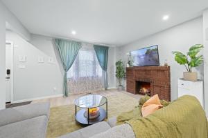 a living room with a couch and a fireplace at Close to mall with private toilet, Free Wi-Fi and Parking in Toronto