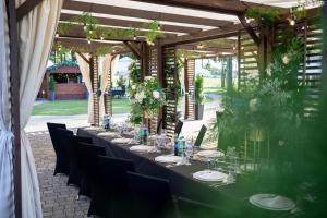 a long table with chairs and glasses on it at Hotel & Spa **** Kasztel Uniejów in Uniejow