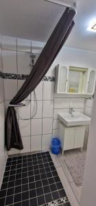 a bathroom with a shower and a sink and a mirror at Break in Kudensee