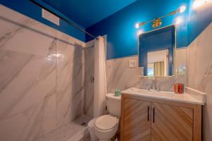 a bathroom with a toilet and a sink and a mirror at Tropical Breeze in Clearwater Beach +216 photos