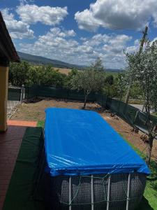 a blue tarp on top of a tennis court at Villa Angelinas in Monte San Savino