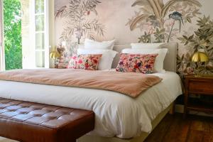 a bedroom with a large bed with floral wallpaper at Pavillon des Millésimes in Lussac +110 photos