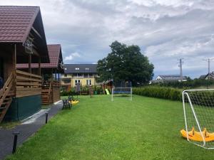 a playground with a soccer goal in a yard at Domki nad morzem u Sumy in Sztutowo