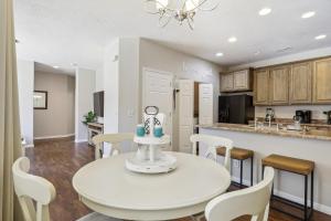 a kitchen and dining room with a white table and chairs at Welcoming Mesquite Condo with Pool Access! in Mesquite