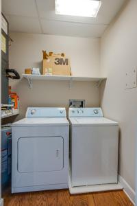 two washer and dryers sitting in a room at Historic Edgefield 2bd 2ba Loft in Nashville
