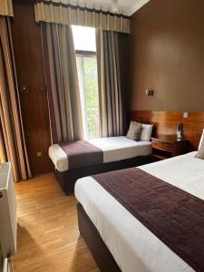 Postel nebo postele na pokoji v ubytování Garden View Hotel